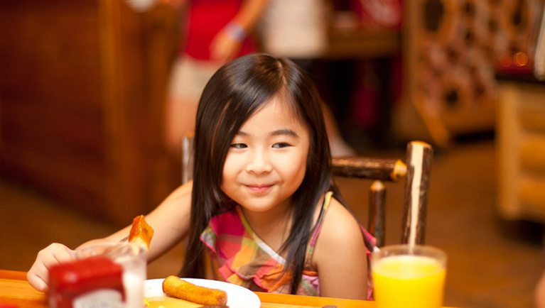 A girl enjoys her plate of food 